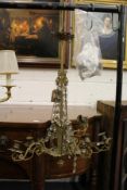 A decorative eight branch brass and cut glass chandelier (AF).