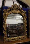 A gilt framed mirror.