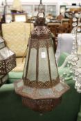A decorative eastern style patinated metal hanging lantern.