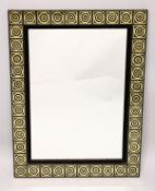 A decoratively framed mirror.