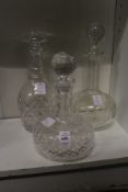 Three cut glass decanters.