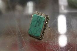 A silver ring inset with hardstone.