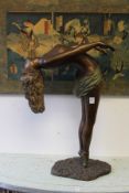 A bronze coloured resin sculpture of a female diver.