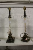 A pair of cut glass and metal lamp bases.