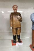 A Russian pottery standing figure holding a pipe.