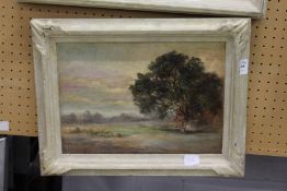 A landscape with figures seated beneath a tree, oil on board, in a painted frame.