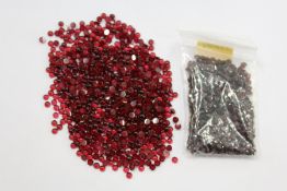 A small bag of red coloured gemstones.