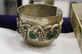 An unusual circular plated metal bowl with inset cabochon stones.
