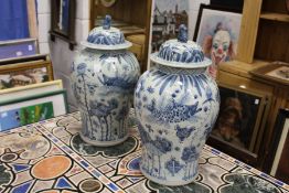 A large pair of Chinese blue and white temple jars and covers.