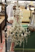 A large decorative cut glass eight branch chandelier.