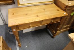 A Victorian style pine two drawer side table.
