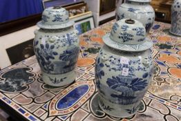 A pair of Chinese blue and white temple jars and covers.