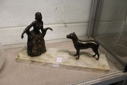 An Art Deco group of a young lady and a dog on a marble base.