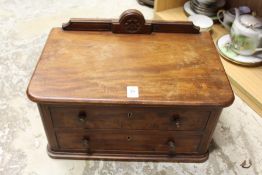 A small mahogany two drawer table top chest.