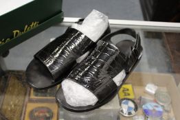 A pair of Louis Vuitton men's black patent crocodile sandals.