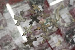 A collection of small early bronze crosses.