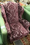 A George III design wing armchair with purple cut velvet fabric on carved cabriole legs with claw