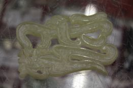 A Chinese carved jade symbol.