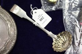 A silver sifting spoon.