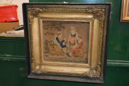 A Victorian embroidered picture in a decorative frame.