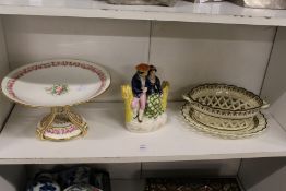 A floral decorated porcelain tazza, a Staffordshire figure group and a creamware chestnut basket and