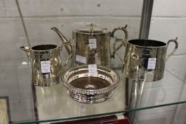 A plated three piece tea service and a bottle coaster.