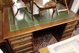 A large mahogany pedestal desk.