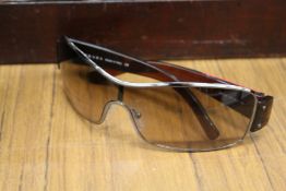 A cased pair of Prada sunglasses.