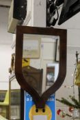 A mahogany shield shaped wall mirror.