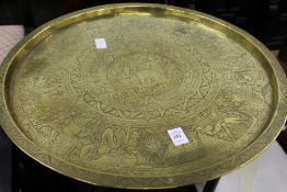 An eastern engraved brass circular tray table.