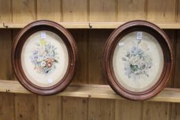 A still life of flowers colour prints, a pair, framed as an oval.