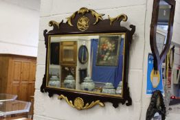 A George III style mahogany and gilt wood fretwork wall mirror.