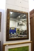 A decorative gilt framed mirror.
