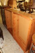 A pair of modern pine open bookcases.