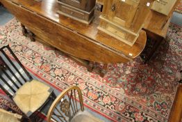 A large Persian design carpet, red ground with broad floral decoration (some wear).