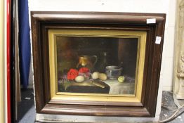 A still life of flowers in a jug on a table, oil on board.
