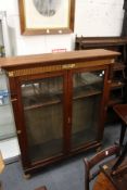 A Victorian walnut two-door glazed bookcase (alterations).