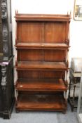 A reproduction hardwood waterfall bookcase.