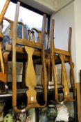 A set of four beech high back dining chairs.
