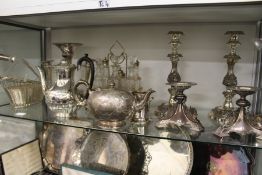 Plated wares to include a pair of ornate stands, candlesticks, an epergne etc.