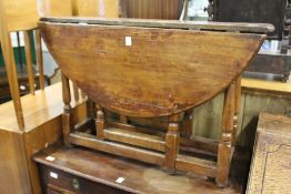 An 18th / 19th century fruitwood oval drop leaf gate leg table.