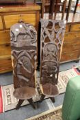 Two carved African hardwood chairs.