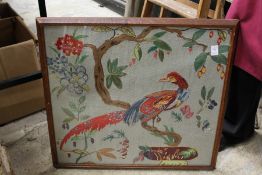 An embroidered picture of an exotic bird.