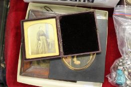 An early photograph of a lady, in a folding leather case and two other items.