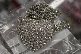 A necklace with heart shaped pendant.