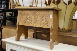 A small carved oak storage box.