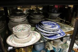 A large shelf of decorative china, glassware etc.