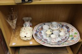 Decorative china and a pair of cut glass champagne flutes.
