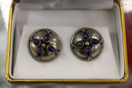 A pair of shield shaped ear studs.