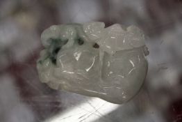 A Chinese carved jade amulet / pebble.